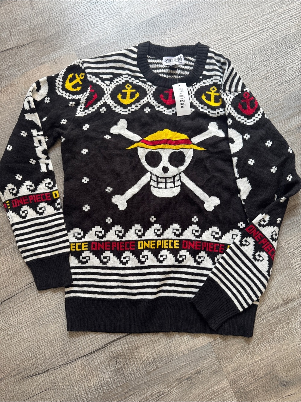 One piece Black Crewneck Sweater with Yellow & Red Skull Emblem